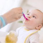 Bébé qui mange un pot de légumes bio